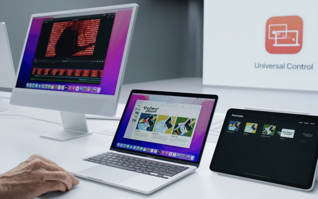 A person uses a white desktop computer, a laptop, and a tablet side by side on a desk, all displaying content; a Universal Control logo is visible in the background.
