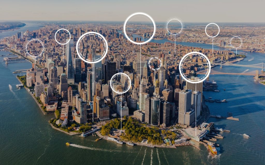 Aerial view of downtown Manhattan, New York City, with digital circles and lines overlayed, suggesting technology, connectivity, or data points across the urban landscape.