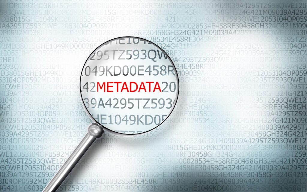A magnifying glass focuses on the word METADATA in red among random alphanumeric codes on a digital background, emphasizing the concept of searching for metadata.