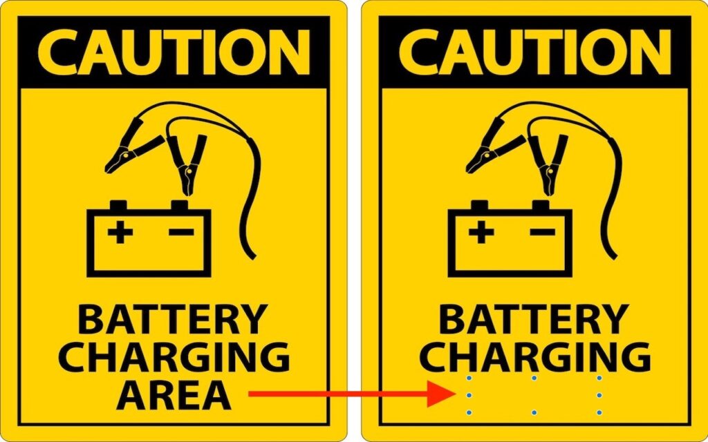 Two yellow caution signs show a car battery with jumper cables. The left sign reads Battery Charging Area. The right sign reads Battery Charging, with the word Area removed and a red arrow pointing to the change.
