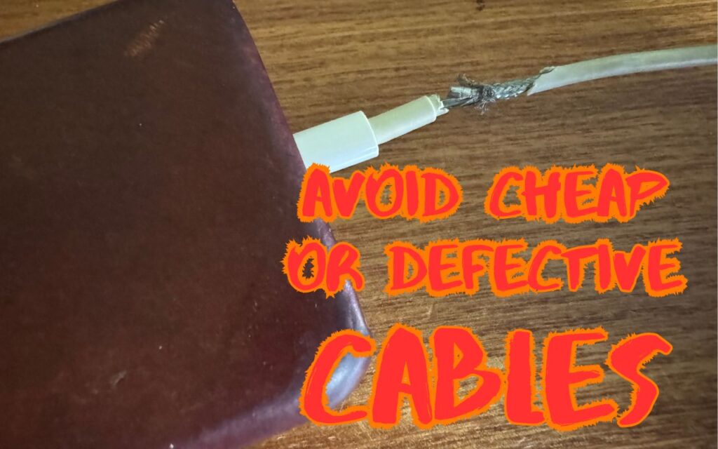 A damaged charging cable plugged into a device on a wooden surface, with the warning text “Use High-Quality Cables for Optimal Performance and Safety” in bold, bright orange letters.