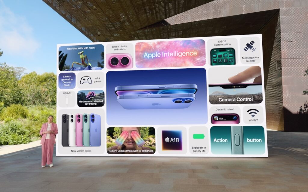 A large display shows Apple iPhone features like Apple Intelligence, new camera, A18 chip, Wi-Fi 7, and AirPods 4. A person in pink stands beside the screen. The setting appears to be an outdoor modern venue.