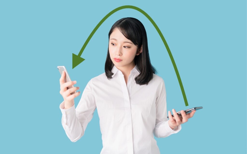 A woman in a white shirt holds two smartphones, looking from one to the other, as a green arrow curves between them on a blue background—illustrating how you can now migrate purchases from one Apple account to another.