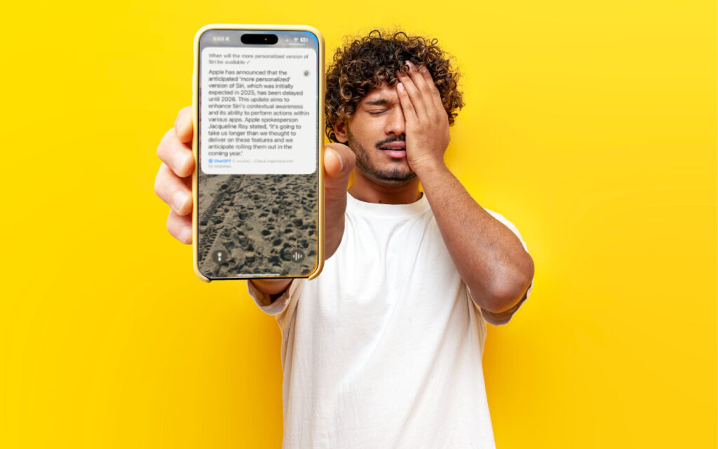 A man in a white t-shirt stands against a bright yellow background, holding an iPhone 15 with apple intelligence displayed, showing a message and an image of the moon’s surface. He covers one eye with his hand, looking frustrated or surprised.