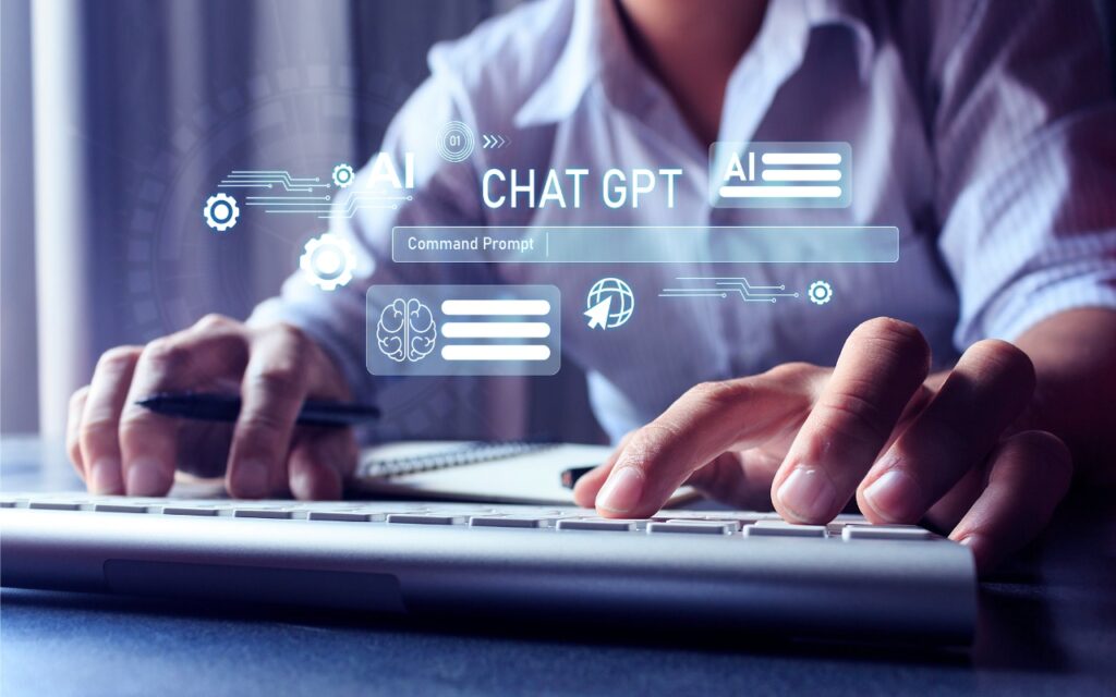 A person types on a keyboard with one hand and holds a pen with the other. Digital graphics display "AI" and "CHAT GPT," suggesting they're exploring Ten Tips for Making the Best Use of AI Chatbots through artificial intelligence technology.