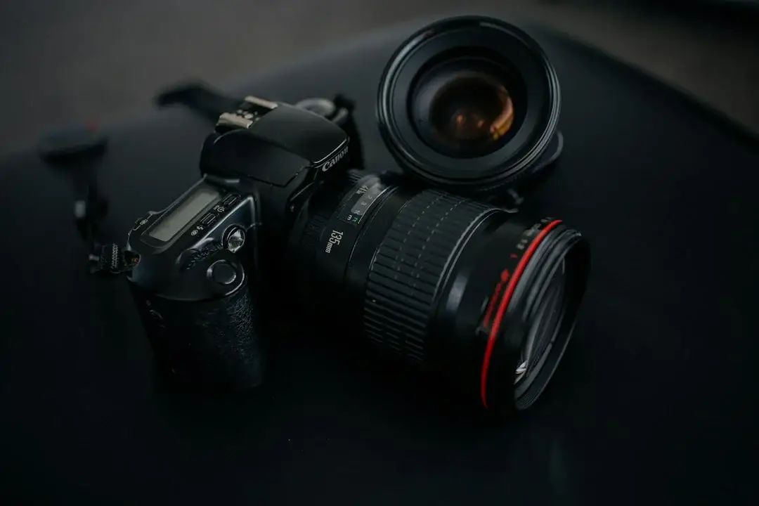 Canon DSLR camera and lens on a studio table, representing a photography studio evaluating IT providers